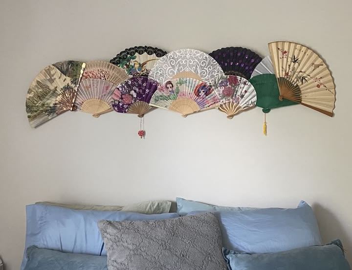  — A collection of decorative folding fans arranged above the bed. by Din Tanovic, Stockholm photo blog