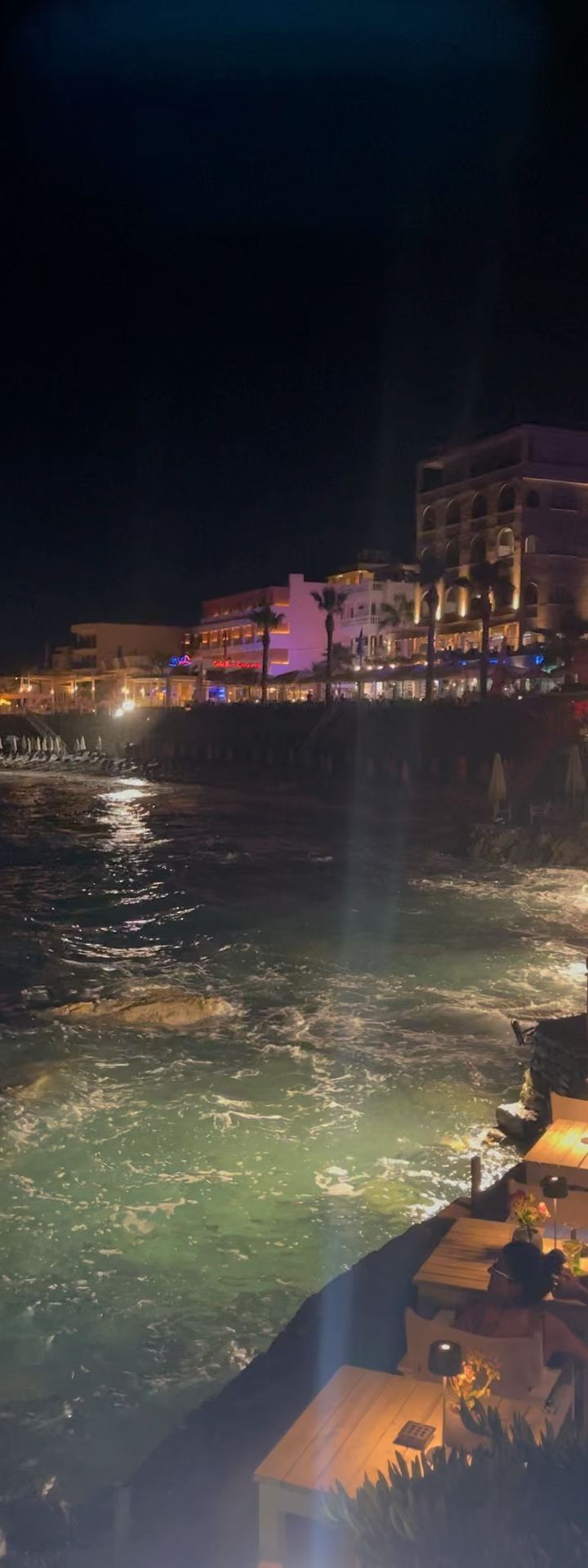 sea at night — candlelight on the cliffs, waves doing the talking. by Din Tanovic, Stockholm photo blog