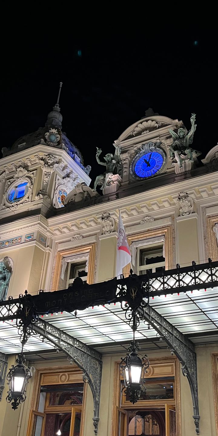 monte carlo at night — casino lights, blue clocks, sea air by Din Tanovic, Stockholm photo blog