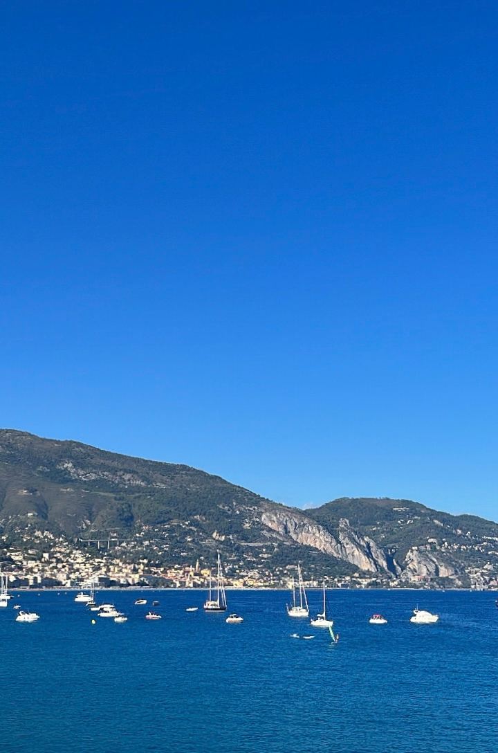 the bay near menton — sailboats anchored under the mountain at midday by Din Tanovic, Stockholm photo blog