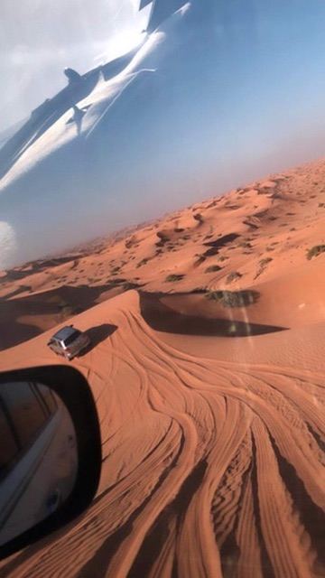 dune drive — red sand, tire lines, the desert's own handwriting. by Din Tanovic, Stockholm photo blog