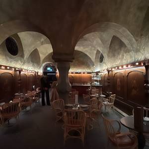 the room · vaults & candlelight — painted vaulted ceiling, rattan chairs, candles — photo by Din Tanovic, Stockholm