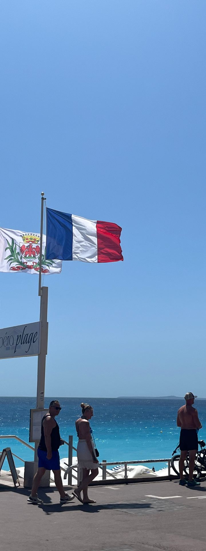 nice · opéra plage, flags in the wind — french and swiss flags above the med by Din Tanovic, Stockholm photo blog