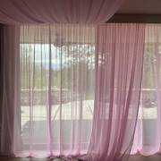 Sheer pink curtains covering large windows, with matching fabric draped across the ceiling.