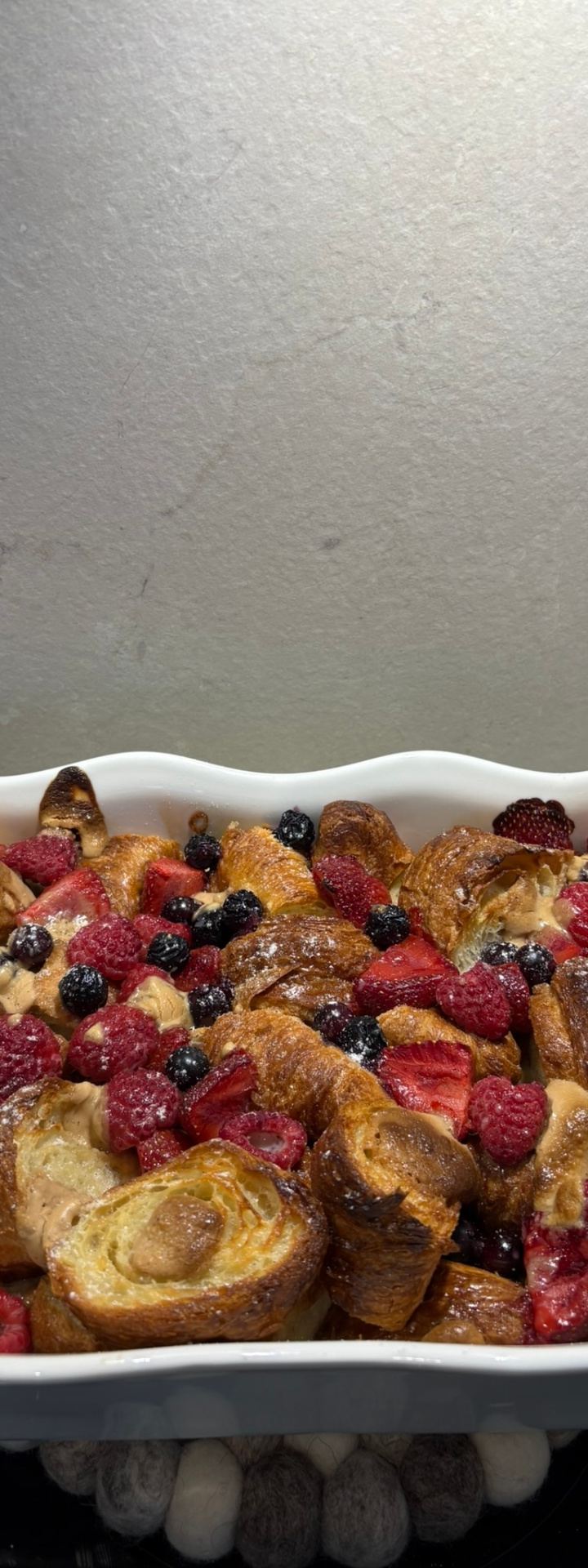 sunday bake — croissants drowning happily in berries and caramel. by Din Tanovic, Stockholm photo blog