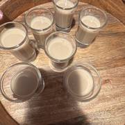 a round on the tray — tray of baileys shots on dark wood