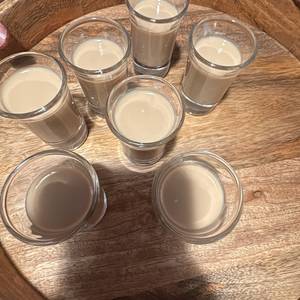 a round on the tray — Din Tanovic a round on the tray — tray of baileys shots on dark wood — photo by Din Tanovic, Stockholm