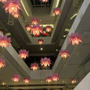 floating lotuses — pink petals suspended between floors.