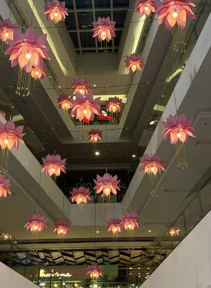 floating lotuses — pink petals suspended between floors.