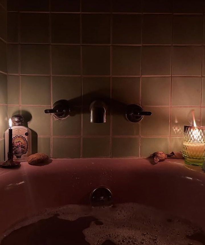 candlelit soak — pink tub, two flames, late hour by Din Tanovic, Stockholm photo blog