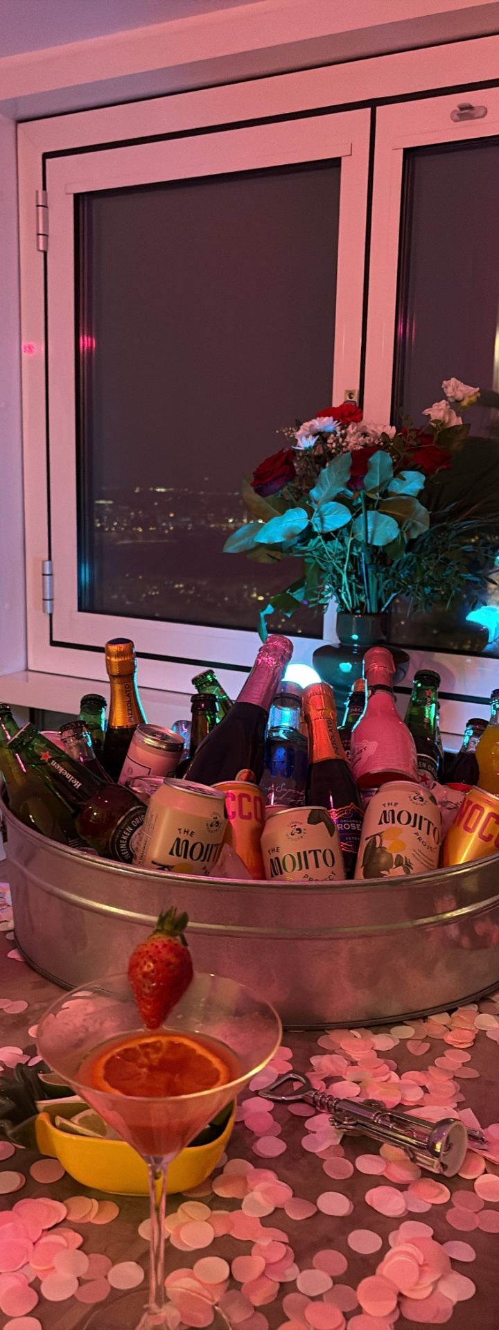 the set-up · pink confetti everywhere — drinks bucket by the window, city lights by Din Tanovic, Stockholm photo blog